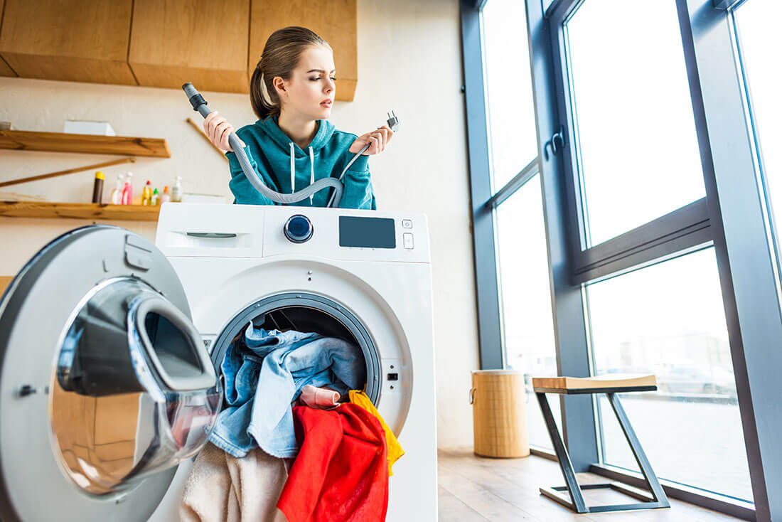 woman looking at laundry hookup